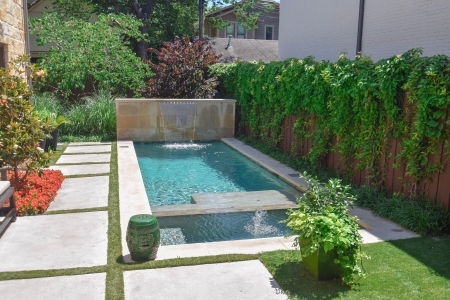 Backyard swimming pool with water feature- Pulliam Pools.