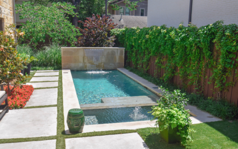 Backyard swimming pool with water feature- Pulliam Pools.