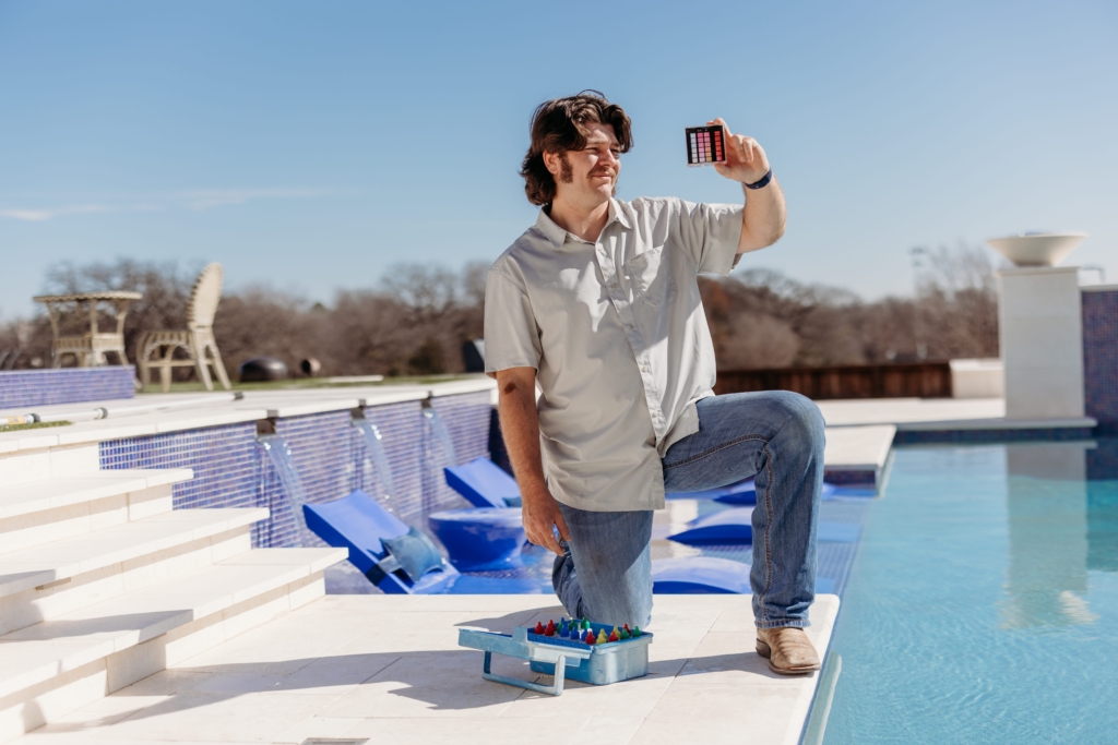 Maintenance guy checking ph level of water.