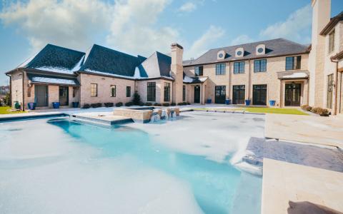 House with luxury outdoor pool thats frozen over.
