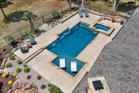 birds eye view of Pool chairs in pool.