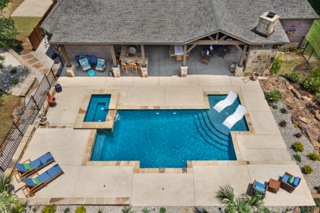 birds eye view of Pool chairs in pool.