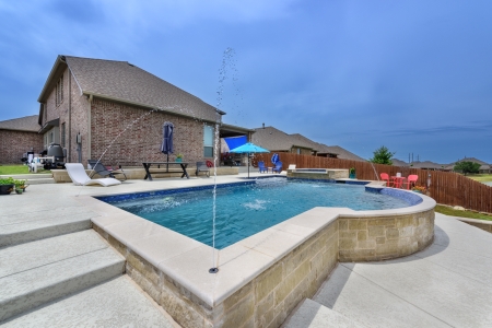 Pool with water sprinklers.