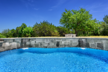 Outdoor pool with blue sky.