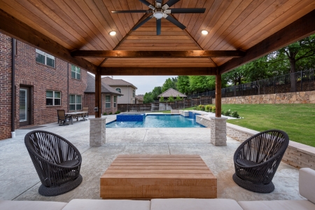 geometric pool with wall and jacuzzi.