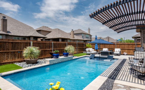 Rectangular pool with sun loungers in pool.