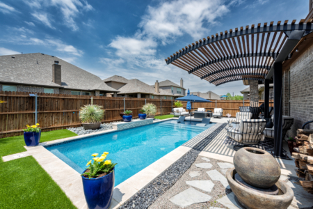 Rectangular pool with sun loungers in pool.
