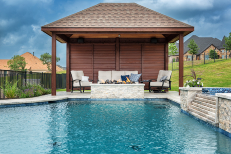 Outdoor seating area by pool with fire pit.