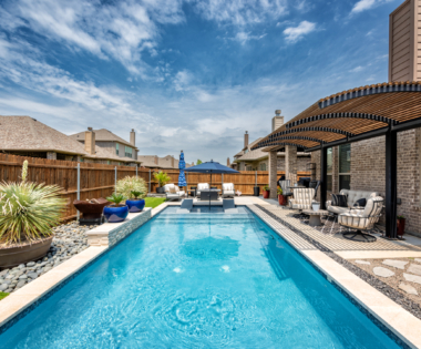 Rectangular pool with sun loungers in pool.