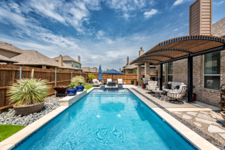 Rectangular pool with sun loungers in pool.