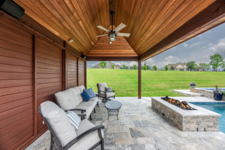 Outdoor seating area by pool with fire pit.