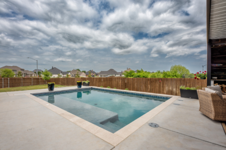 Rectangular pool on cloudy day.
