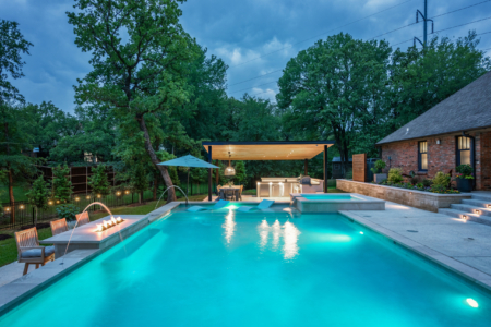 Rectangular pool at night lit up.