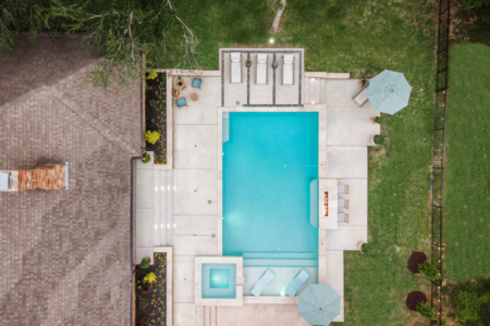 Birds eye view of geometric pool with seating.