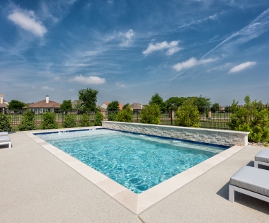 Pool with a concrete deck.