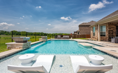 Lounge chairs in pool.