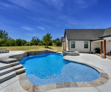 free form pool with blue sky.