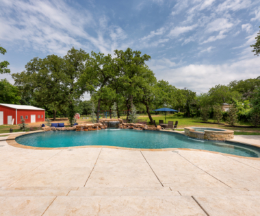 View of freeform pool with yard.