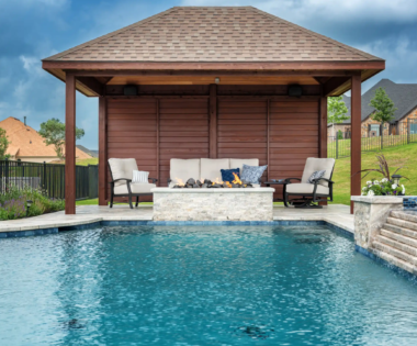 Outdoor seating area by pool with fire pit.